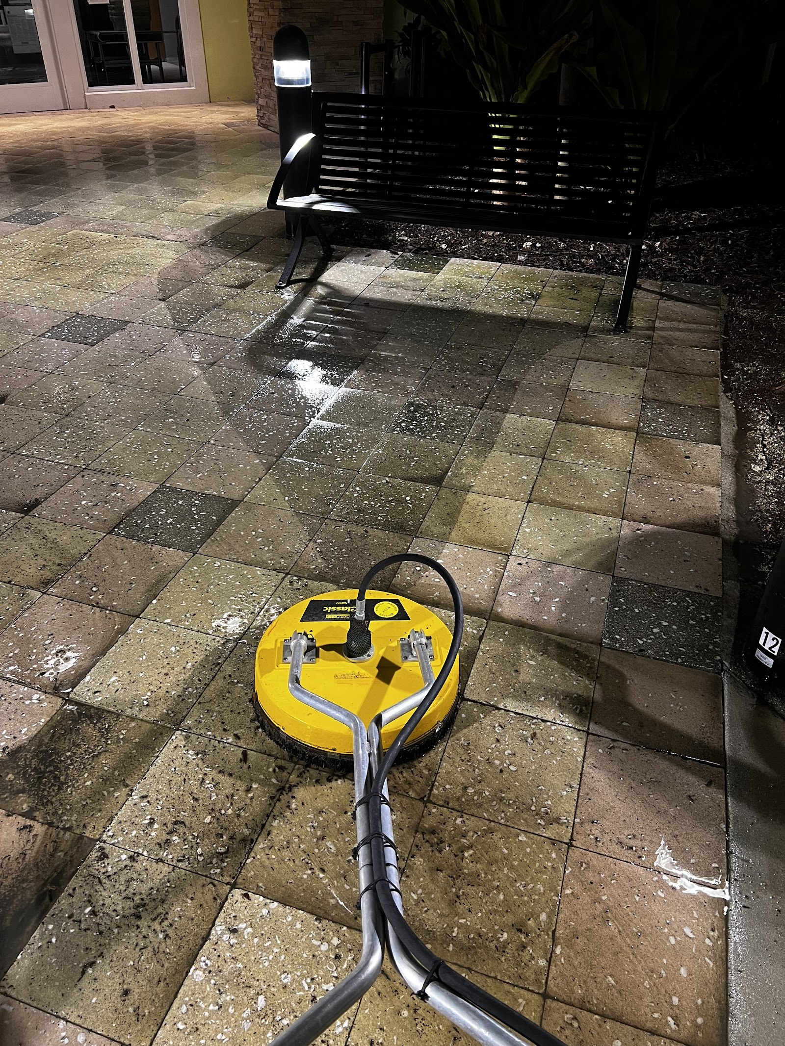 Surface cleaner in action on a paver patio